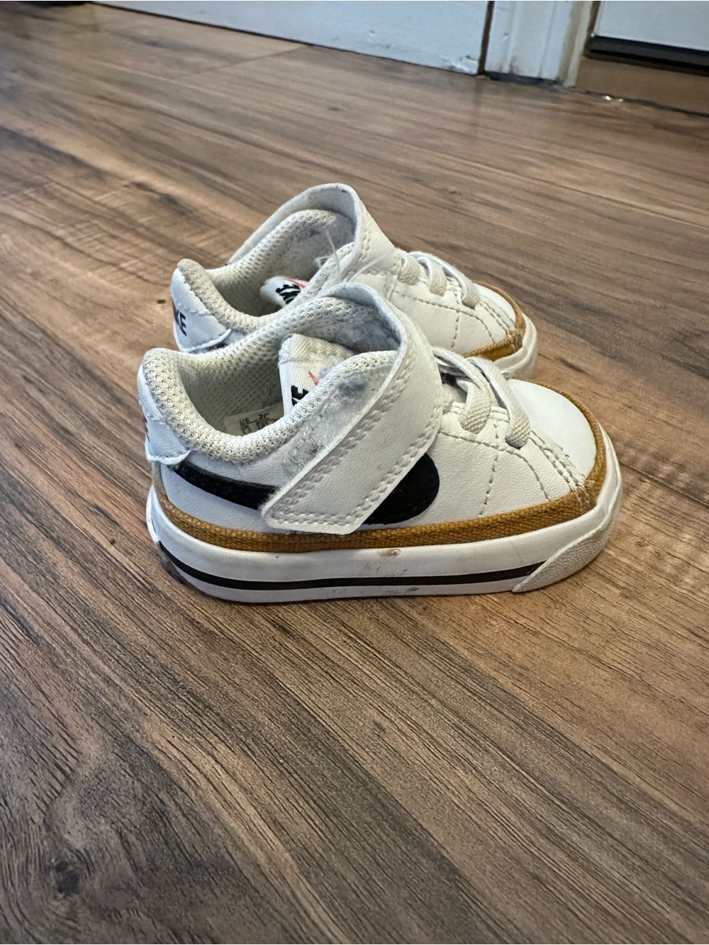 Nike Kids White Sneakers with Black Swoosh and Brown Trim